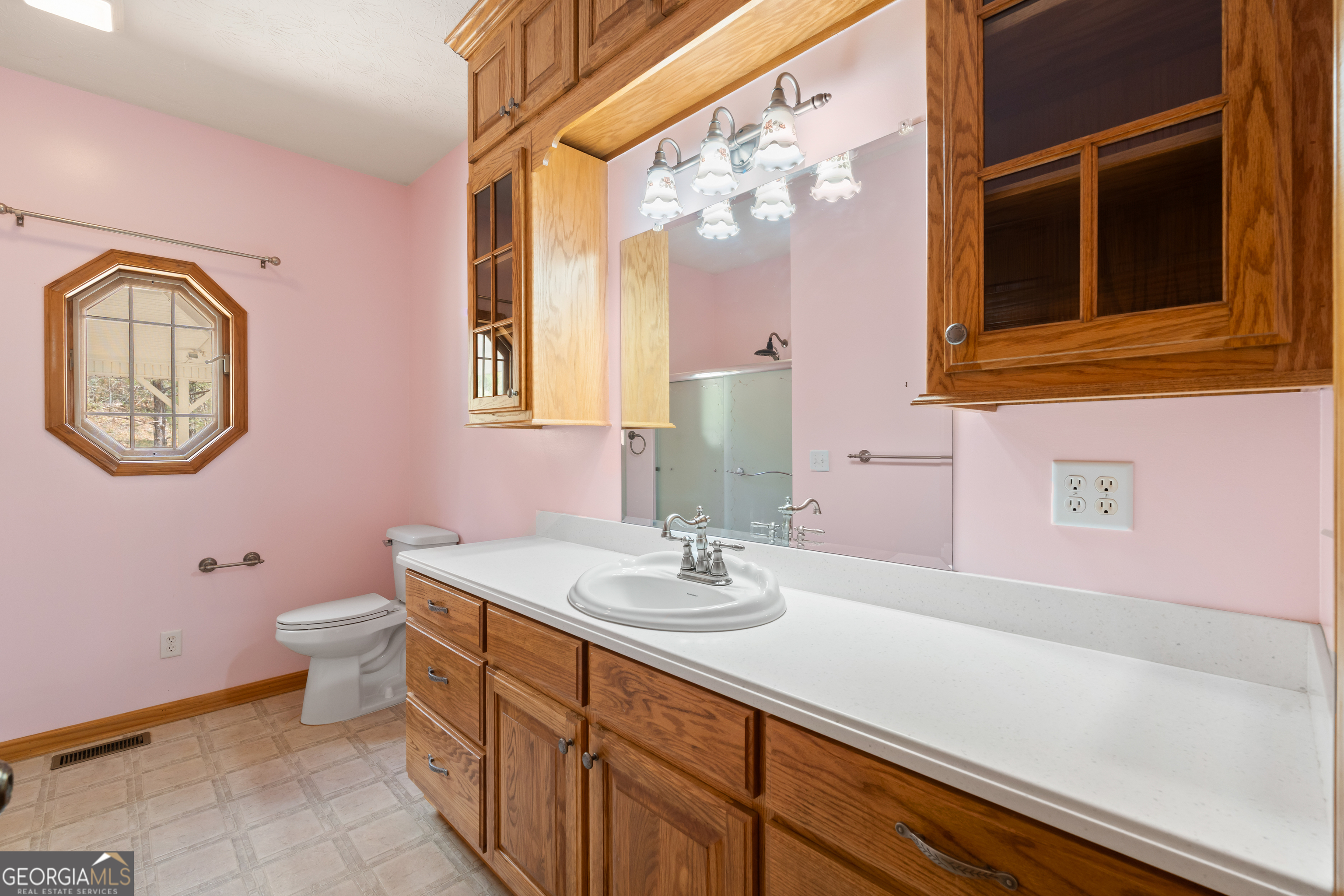 1229 Boggus Road Franklin, GA 30217 - Photo 22 of 68 a bathroom with a sink a mirror and a toilet