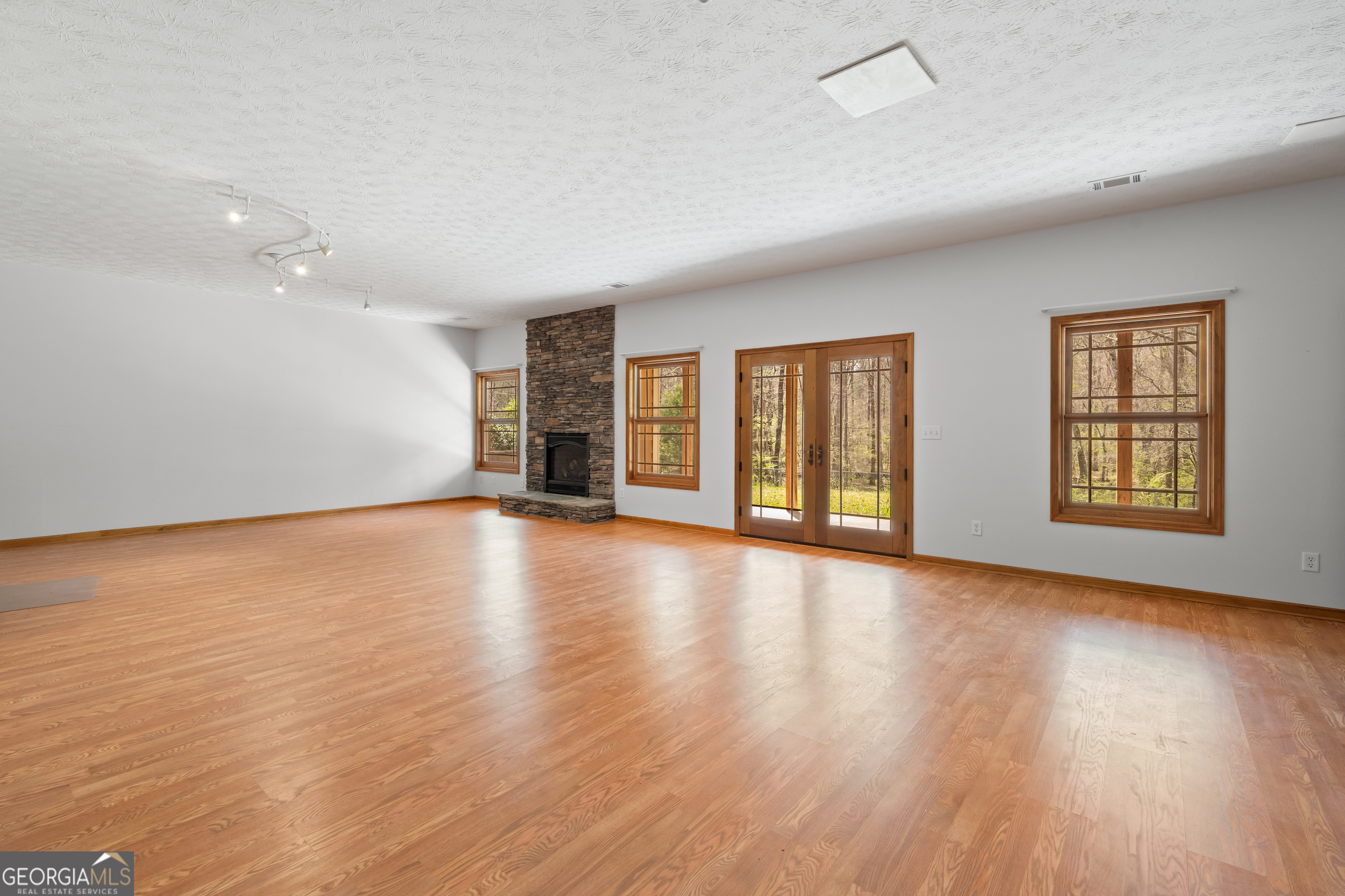 1229 Boggus Road Franklin, GA 30217 - Photo 34 of 68 a view of an empty room with wooden floor and windows