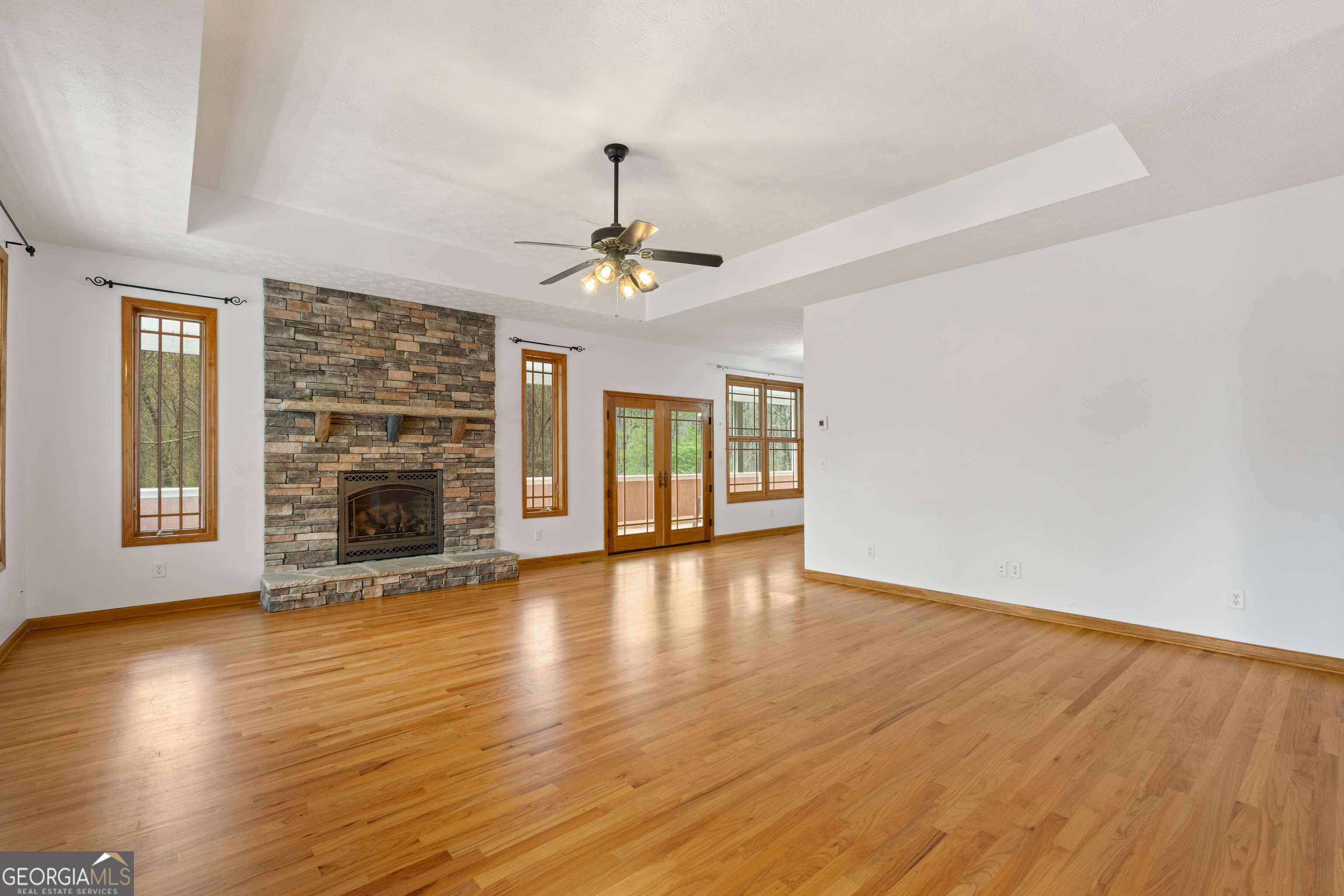 1229 Boggus Road Franklin, GA 30217 - Photo 10 of 68 a view of an empty room with a window and wooden floor