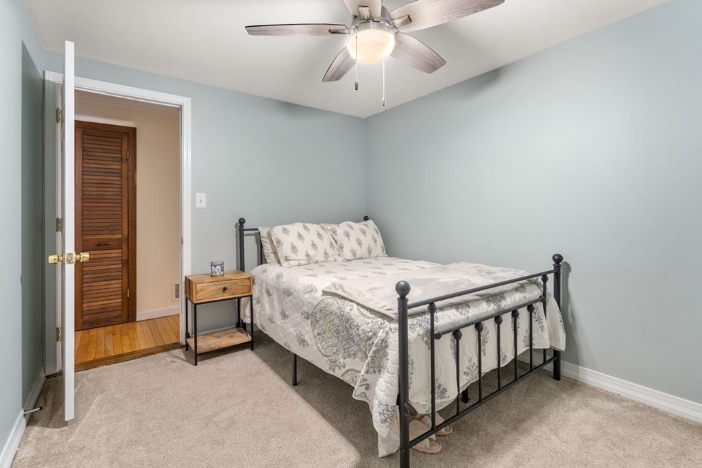 21 Fayette Street Watertown, MA 02472 - Photo 11 of 25 a bedroom with a bed and a chandelier