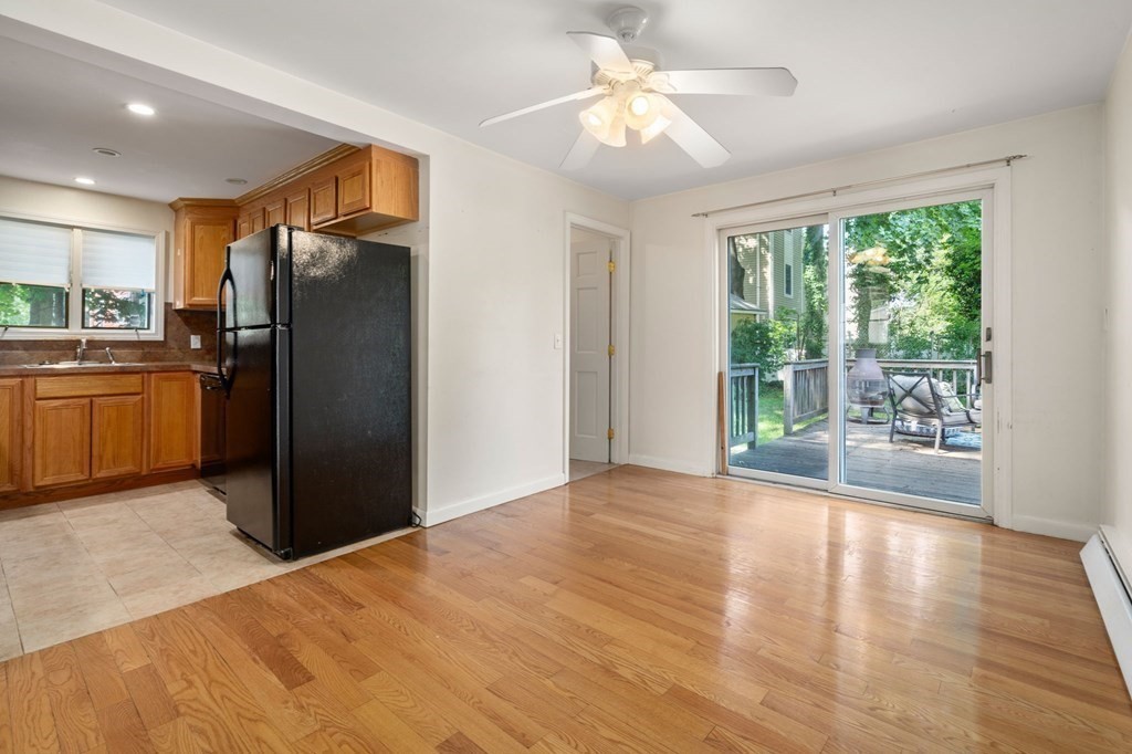 21 Fayette Street Watertown, MA 02472 - Photo 16 of 25 a view of a kitchen with a stove fridge and wooden floor