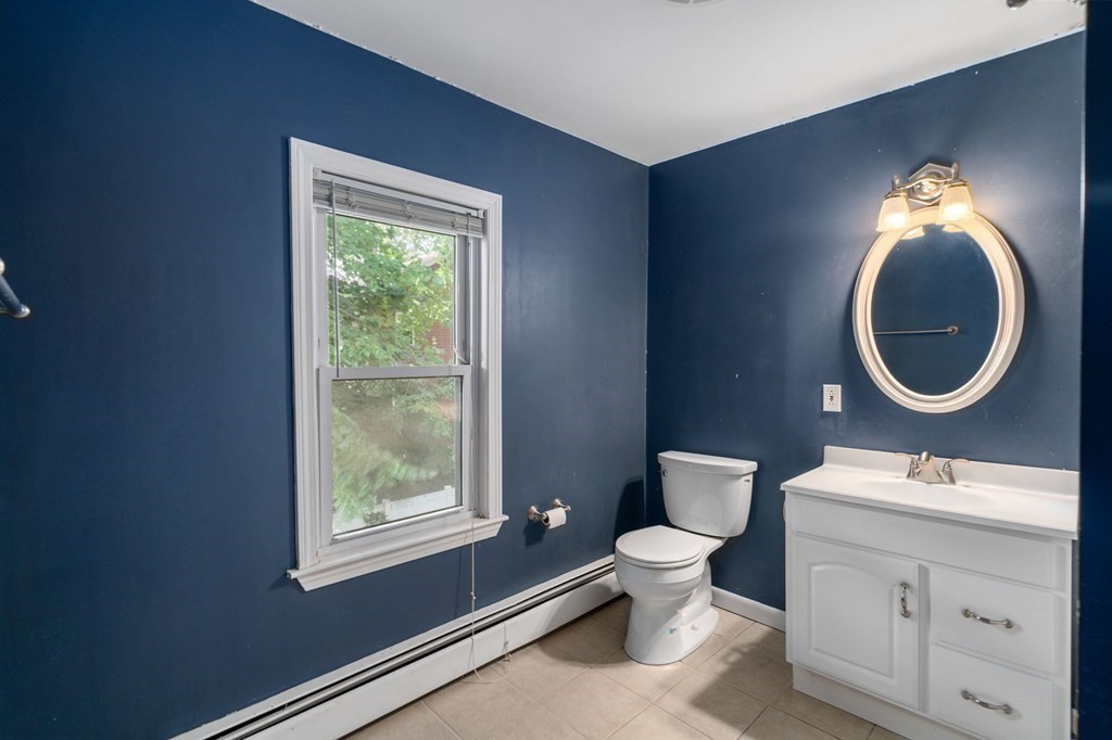21 Fayette Street Watertown, MA 02472 - Photo 18 of 25 a bathroom with a toilet a sink and a mirror