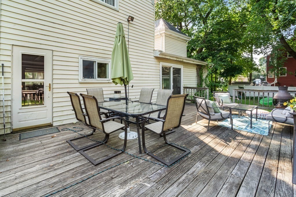 21 Fayette Street Watertown, MA 02472 - Photo 21 of 25 a view of a roof deck with table and chairs and wooden floor