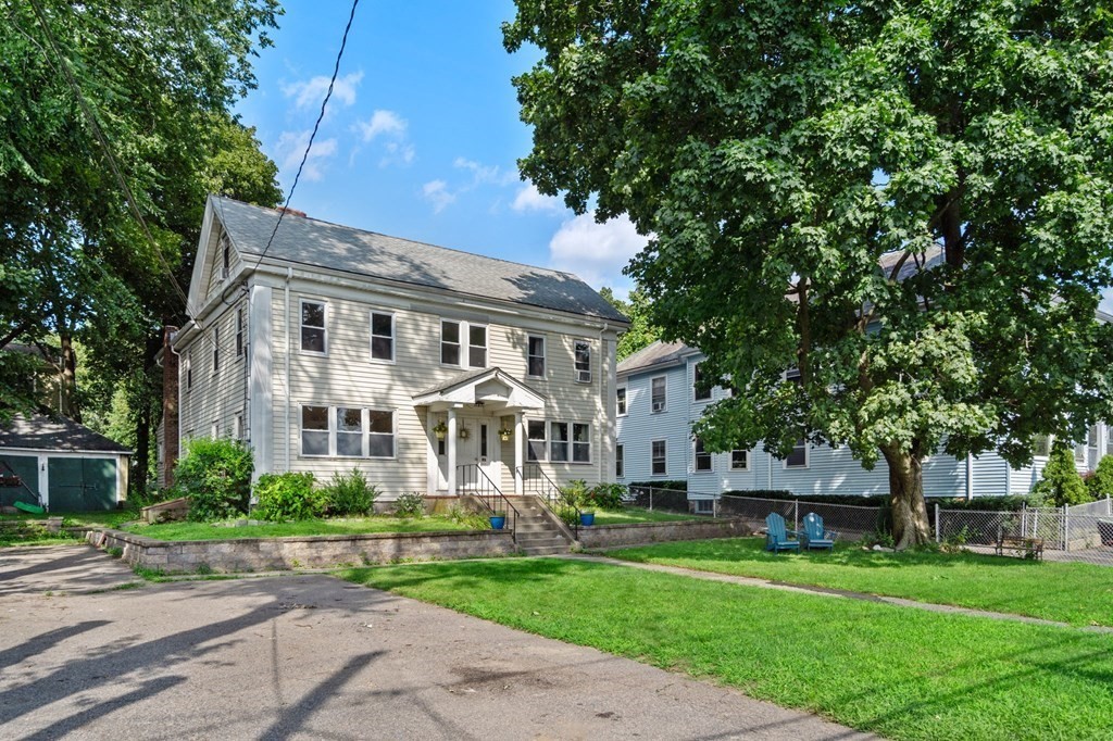 21 Fayette Street Watertown, MA 02472 - Photo 3 of 25 a front view of a house with a garden and trees