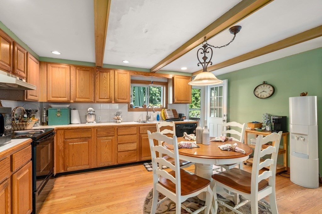 21 Fayette Street Watertown, MA 02472 - Photo 8 of 25 a kitchen with stainless steel appliances kitchen island granite countertop a table chairs stove and cabinets