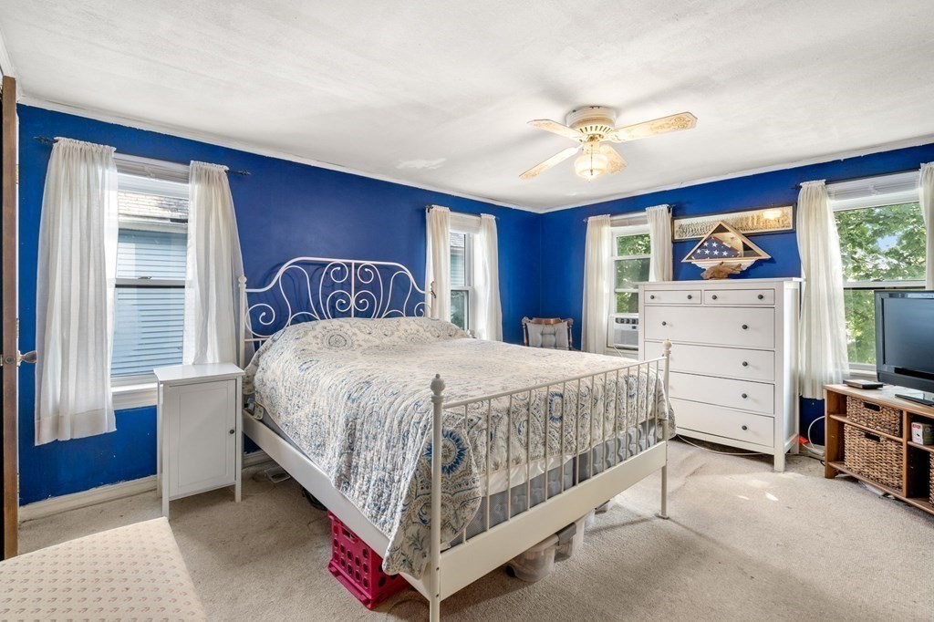 21 Fayette Street Watertown, MA 02472 - Photo 9 of 25 a bedroom with a bed and a flat tv screen on dresser