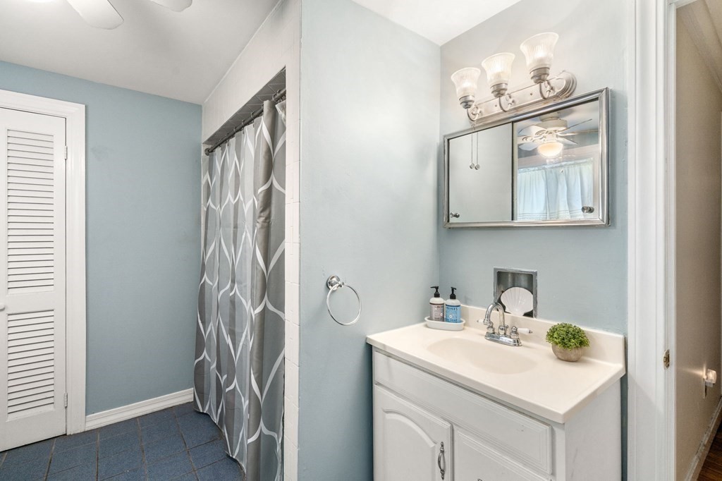 21 Fayette Street Watertown, MA 02472 - Photo 10 of 25 a bathroom with a sink a mirror and vanity