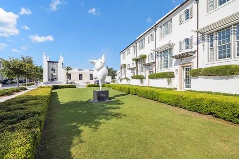 a living room with furniture a flat screen tv and a chandelier