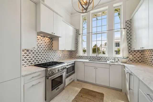 a front view of a house with white fence