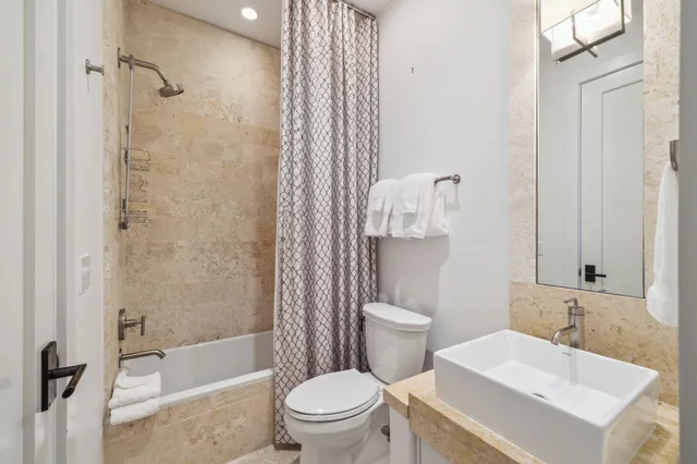 an aerial view of residential houses with outdoor space and parking