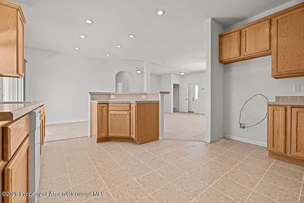 a view of kitchen with stainless steel appliances granite countertop a stove a sink a refrigerator and cabinets
