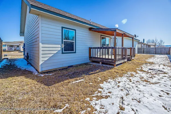 a view of a house with wooden fence