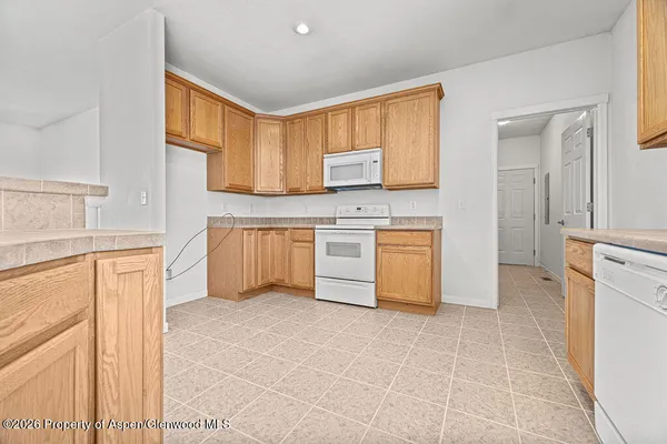 a kitchen with a stove a sink and a refrigerator