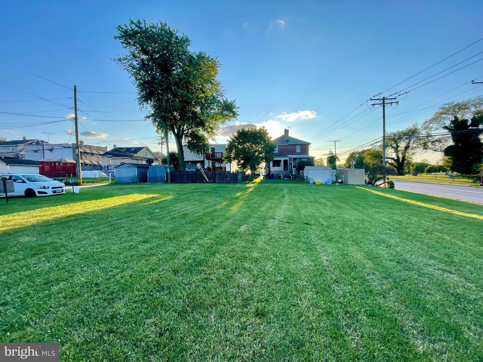 a view of a field of grass and trees