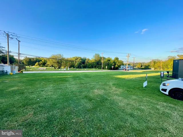 a view of a grassy field with sitting area