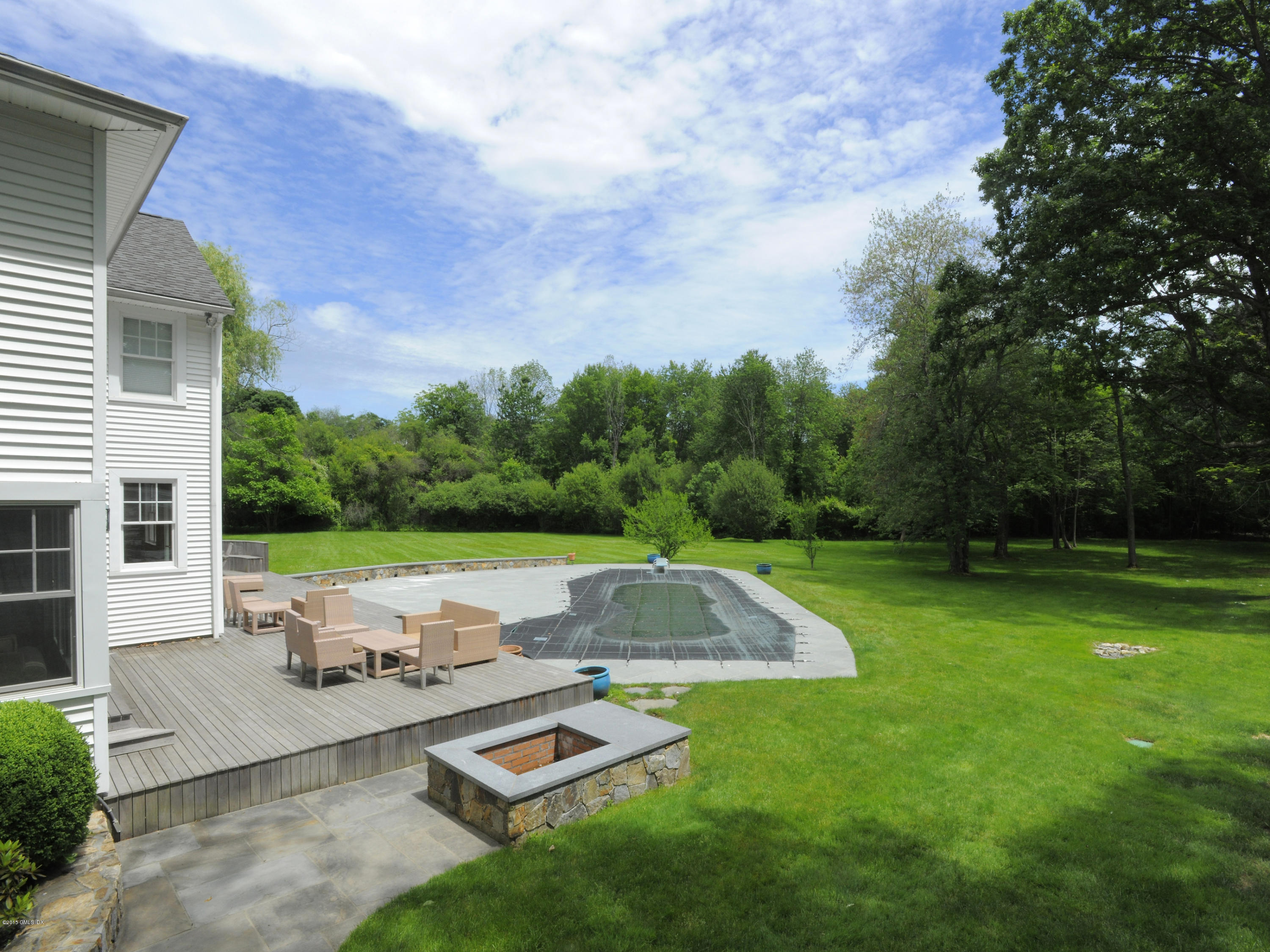 48 Locust Road Greenwich, CT 06831 - Photo 2 of 20 a view of backyard with swimming pool and outdoor seating