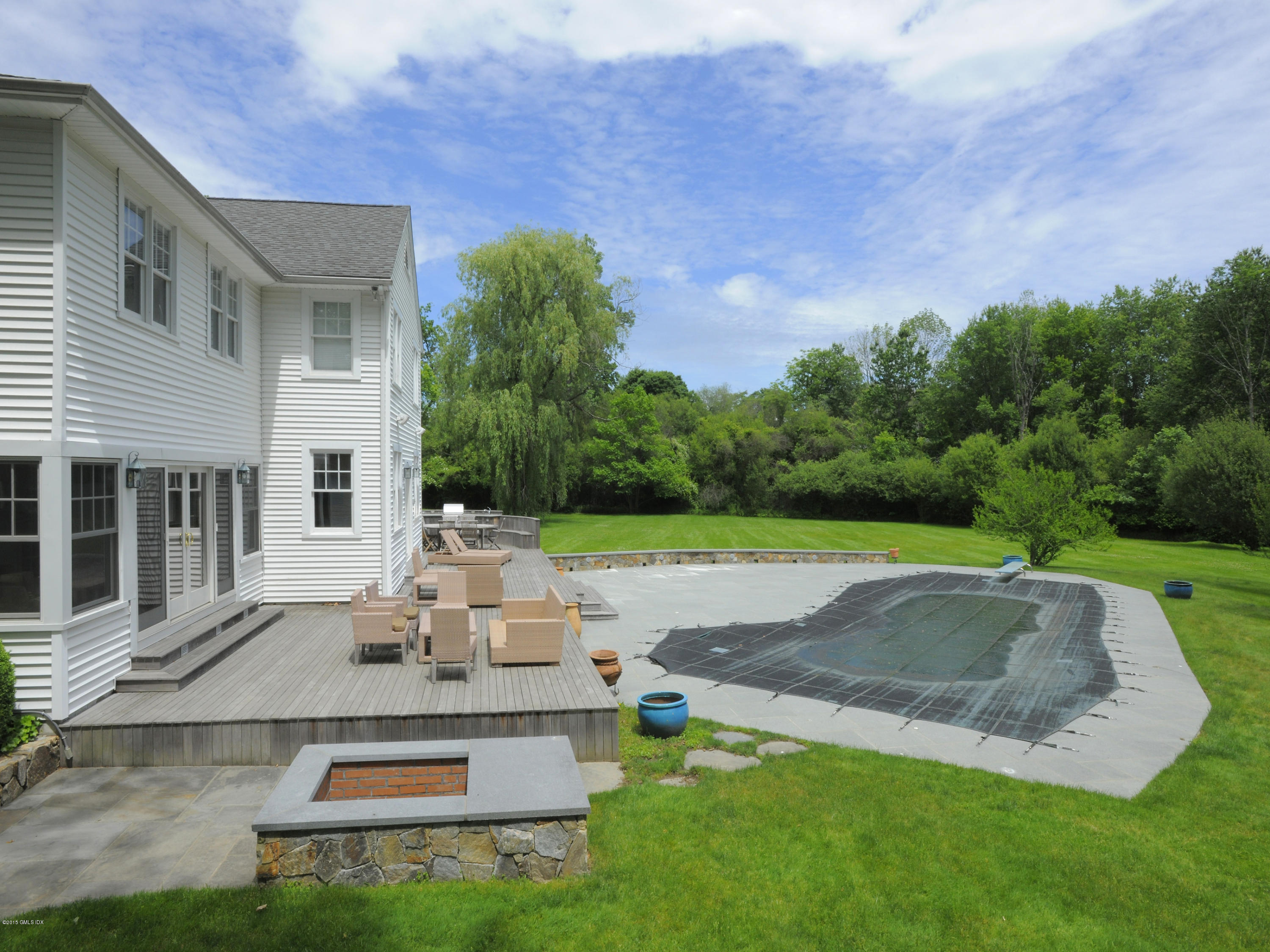 48 Locust Road Greenwich, CT 06831 - Photo 3 of 20 a view of a backyard with a garden and entertaining space