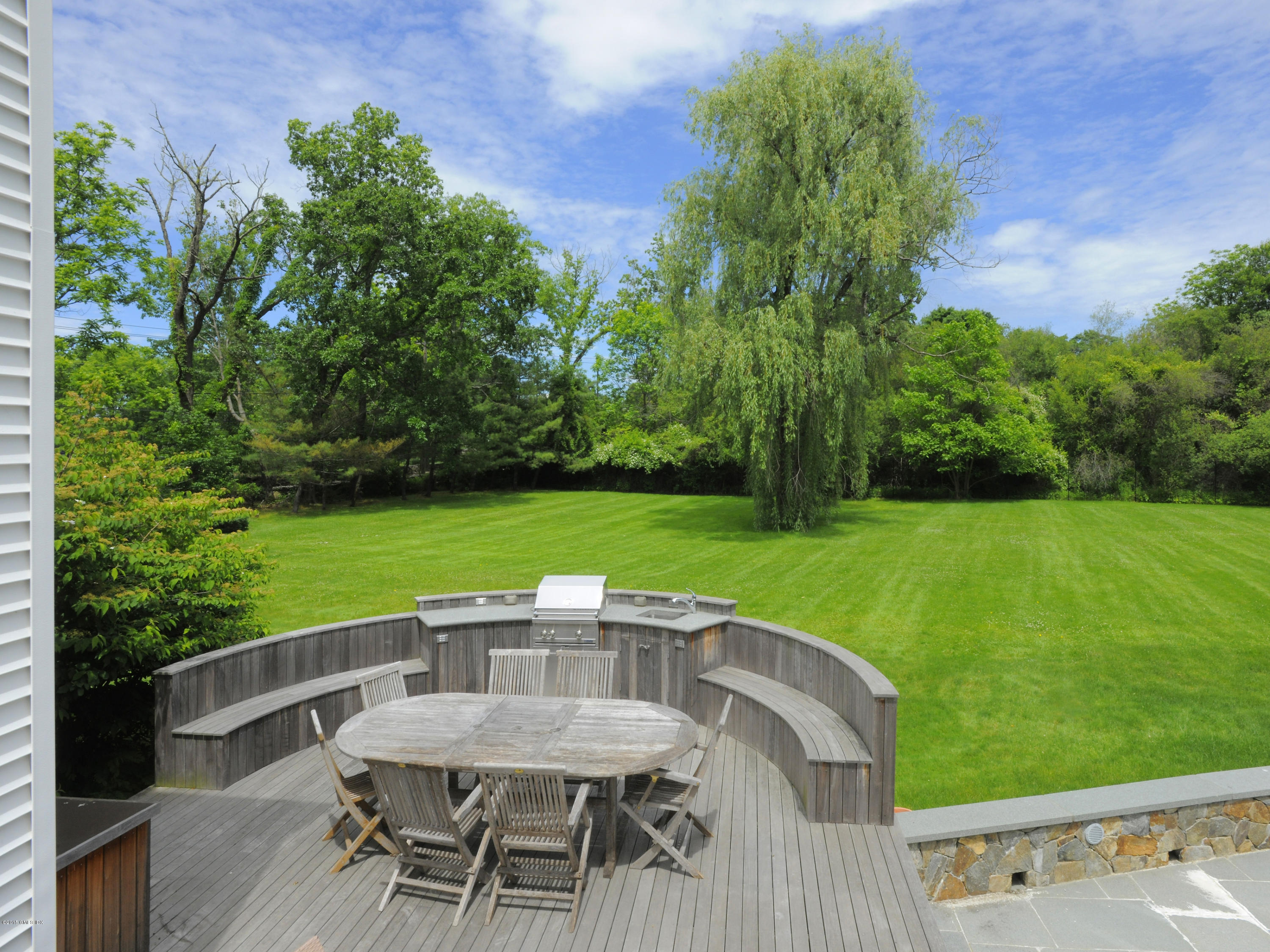 48 Locust Road Greenwich, CT 06831 - Photo 5 of 20 a view of a chairs and table on the patio