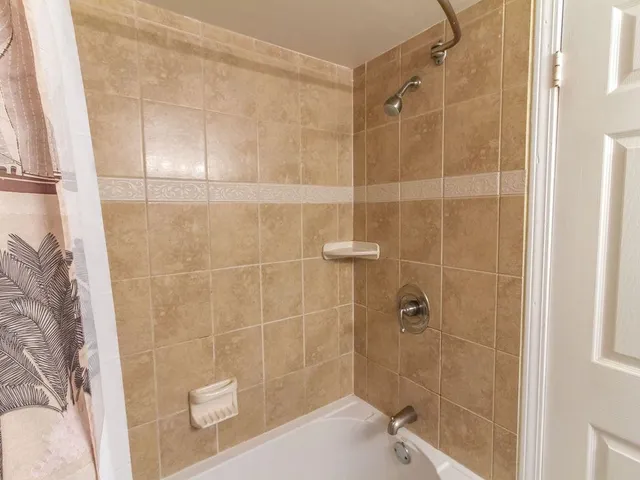 a view of a terrace with lawn chairs