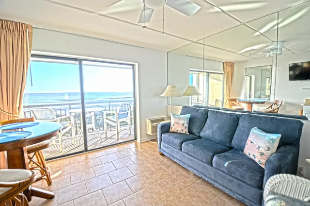 a view of a room with furniture and floor to ceiling windows