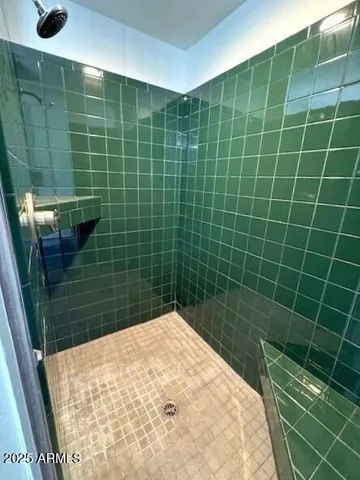 a spacious bathroom with a granite countertop sink and a mirror