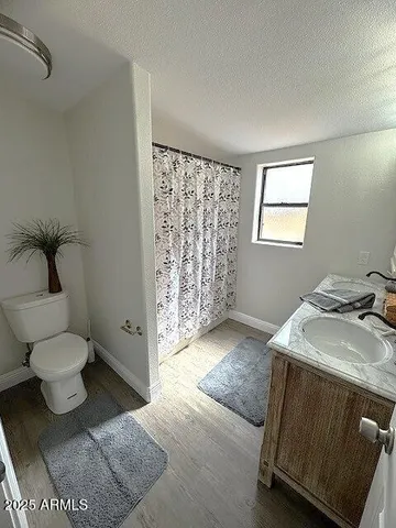 a bathroom with a toilet sink and shower