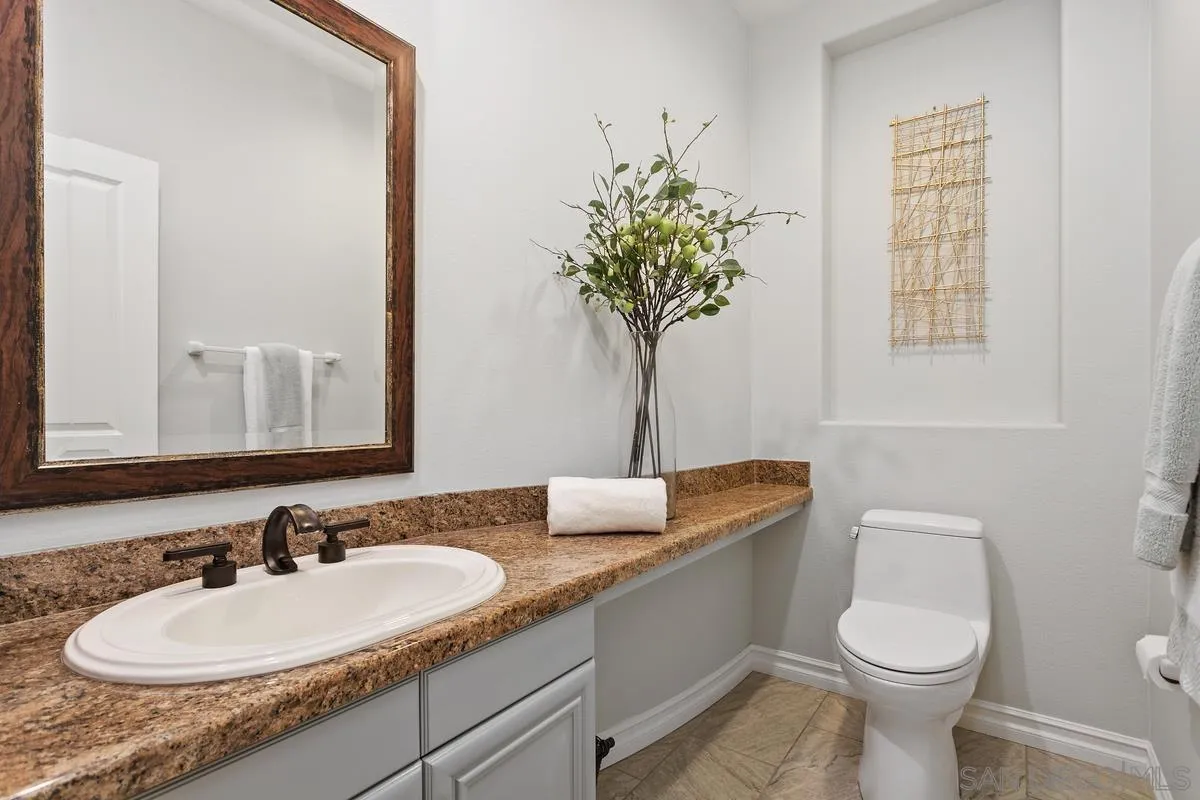 16309 Deer Ridge Road San Diego, CA 92127 - Photo 16 of 37 a bathroom with a granite countertop toilet sink and mirror