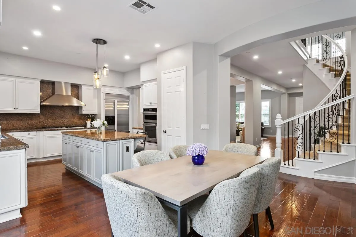 16309 Deer Ridge Road San Diego, CA 92127 - Photo 18 of 37 a large kitchen with cabinets table and chairs