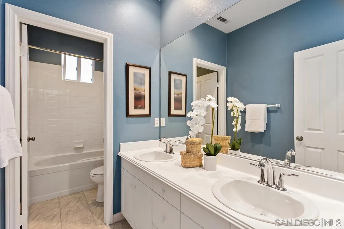 16309 Deer Ridge Road San Diego, CA 92127 - Photo 33 of 37 a bathroom with a granite countertop sink a toilet and shower