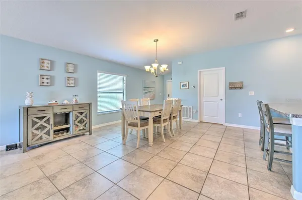 a view of a dining room with furniture and chandelier