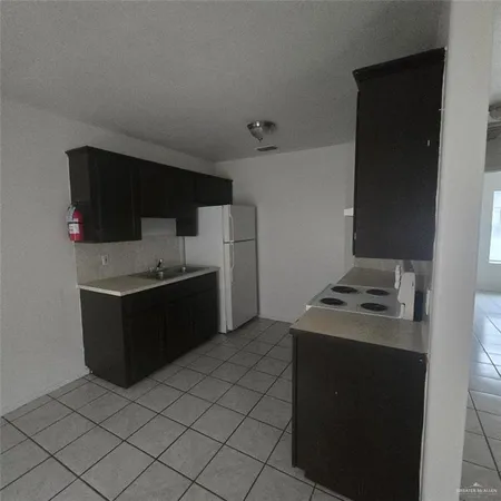 a kitchen with a stove and a refrigerator