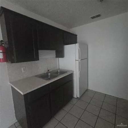 a kitchen with a sink and a refrigerator