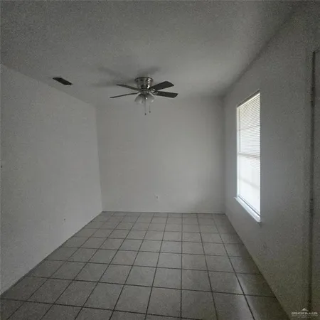 a view of an empty room and a window