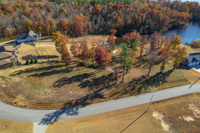 a view of a yard with wooden fence