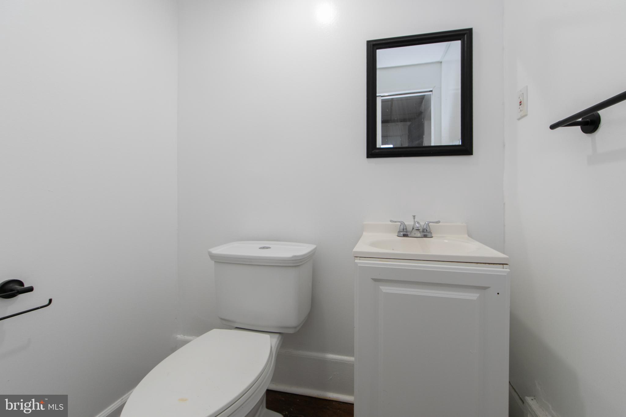 513 Benson Street Camden, NJ 08103 - Photo 15 of 37 a white toilet sitting next to a bathroom sink
