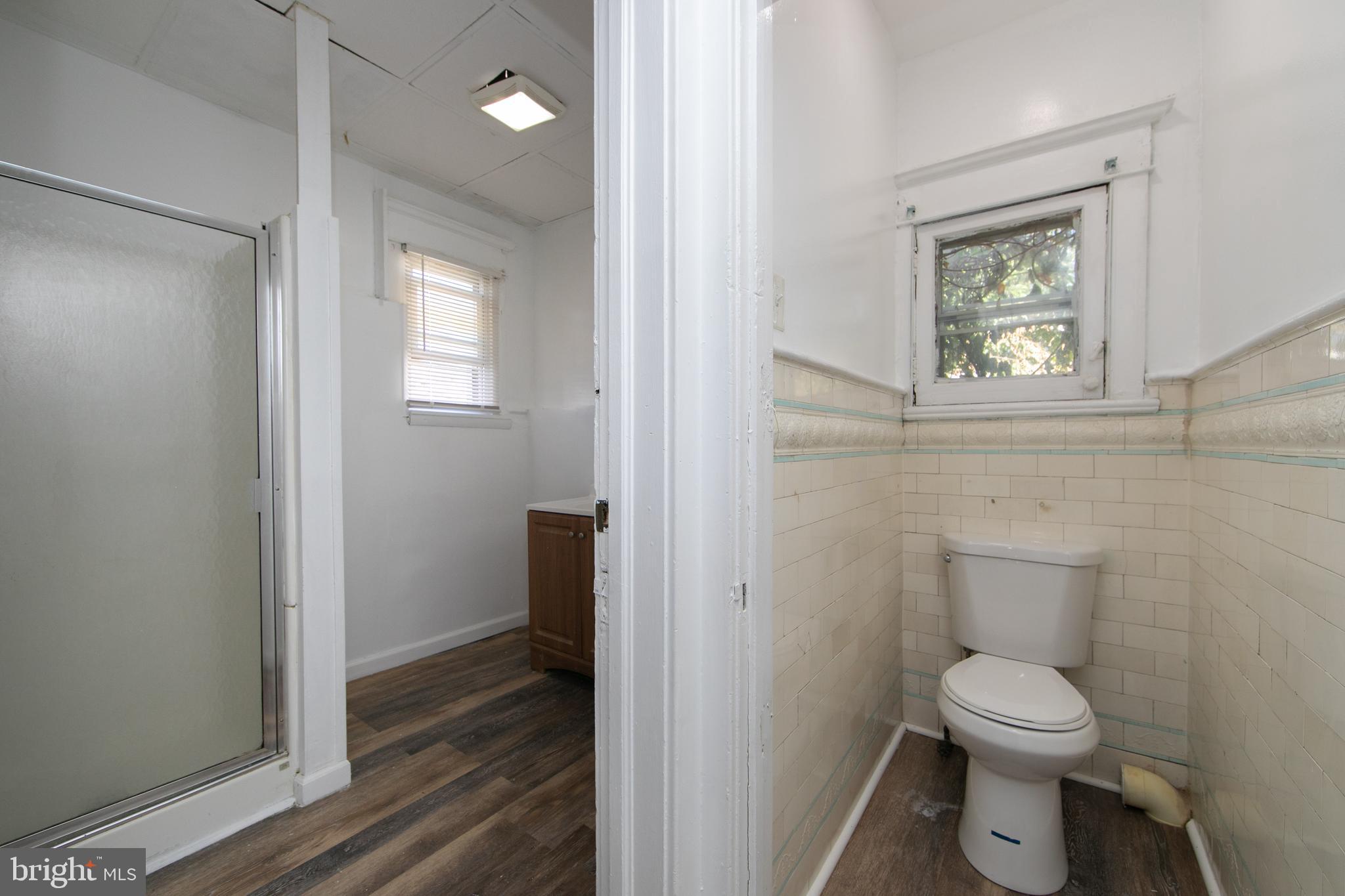 513 Benson Street Camden, NJ 08103 - Photo 27 of 37 a bathroom with a toilet a sink and a window