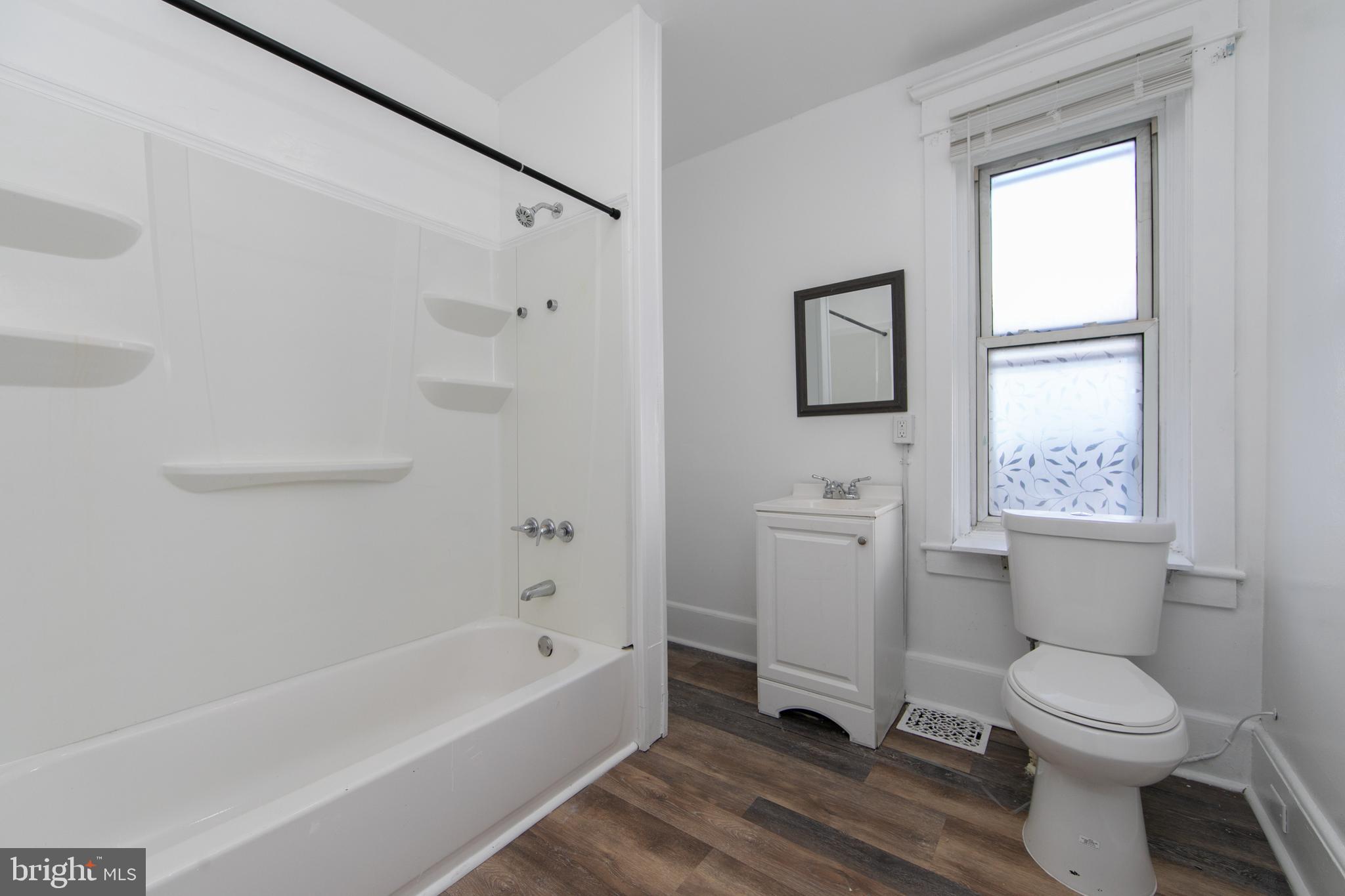 513 Benson Street Camden, NJ 08103 - Photo 29 of 37 a bathroom with a toilet a sink and bathtub