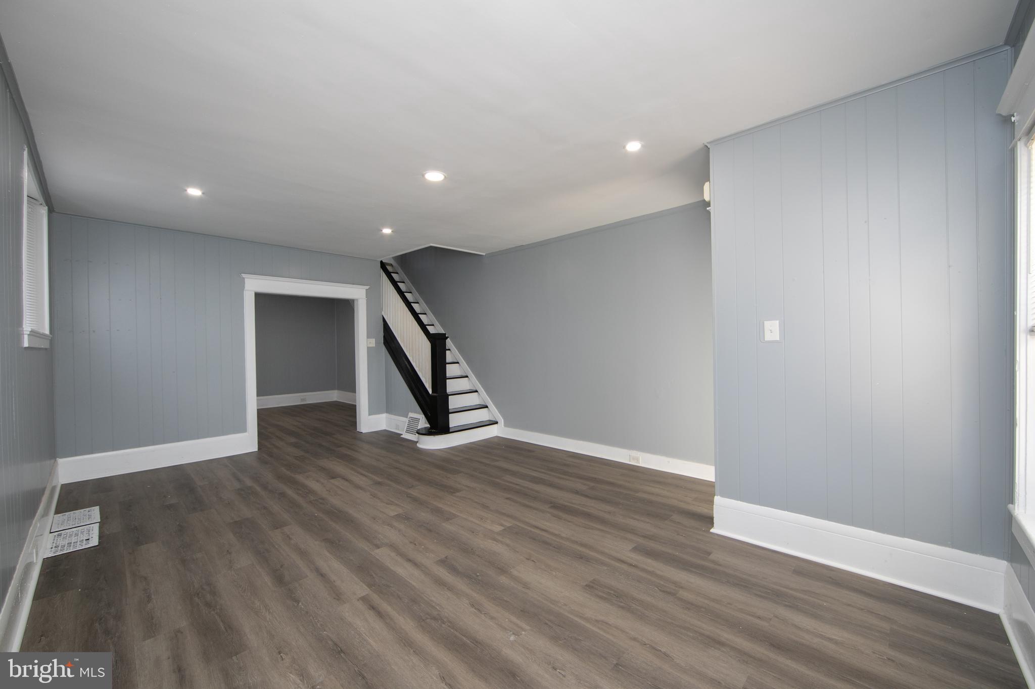513 Benson Street Camden, NJ 08103 - Photo 3 of 37 a view of an empty room with wooden floor and stairs