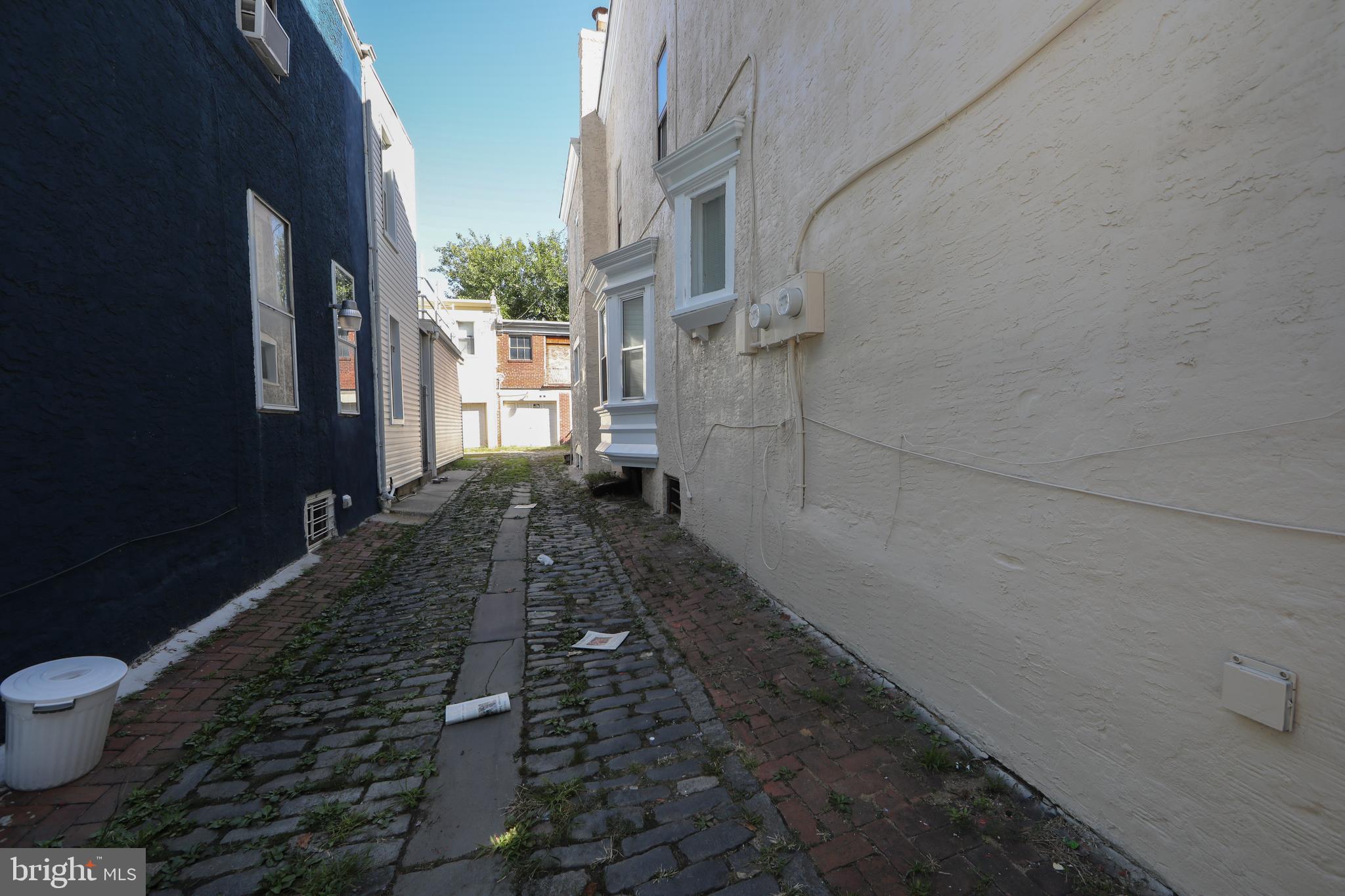 513 Benson Street Camden, NJ 08103 - Photo 37 of 37 a bathroom with a granite countertop sink a toilet and a blue shower