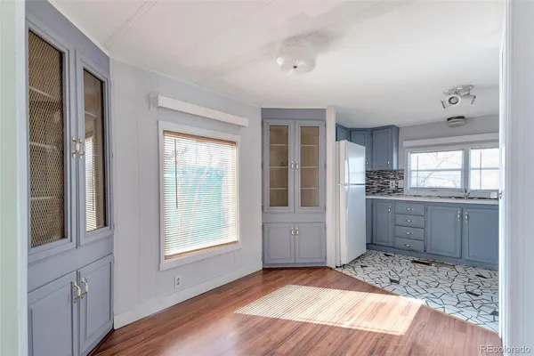 a very nice looking room with a large window and wooden floor