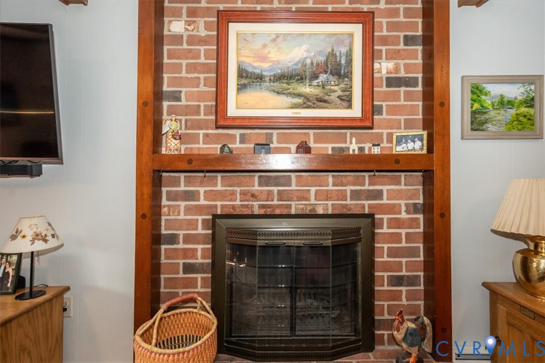 10712 Lunswood Road Chester, VA 23831 - Photo 14 of 31 Brick-faced fireplace with a black metal insert an