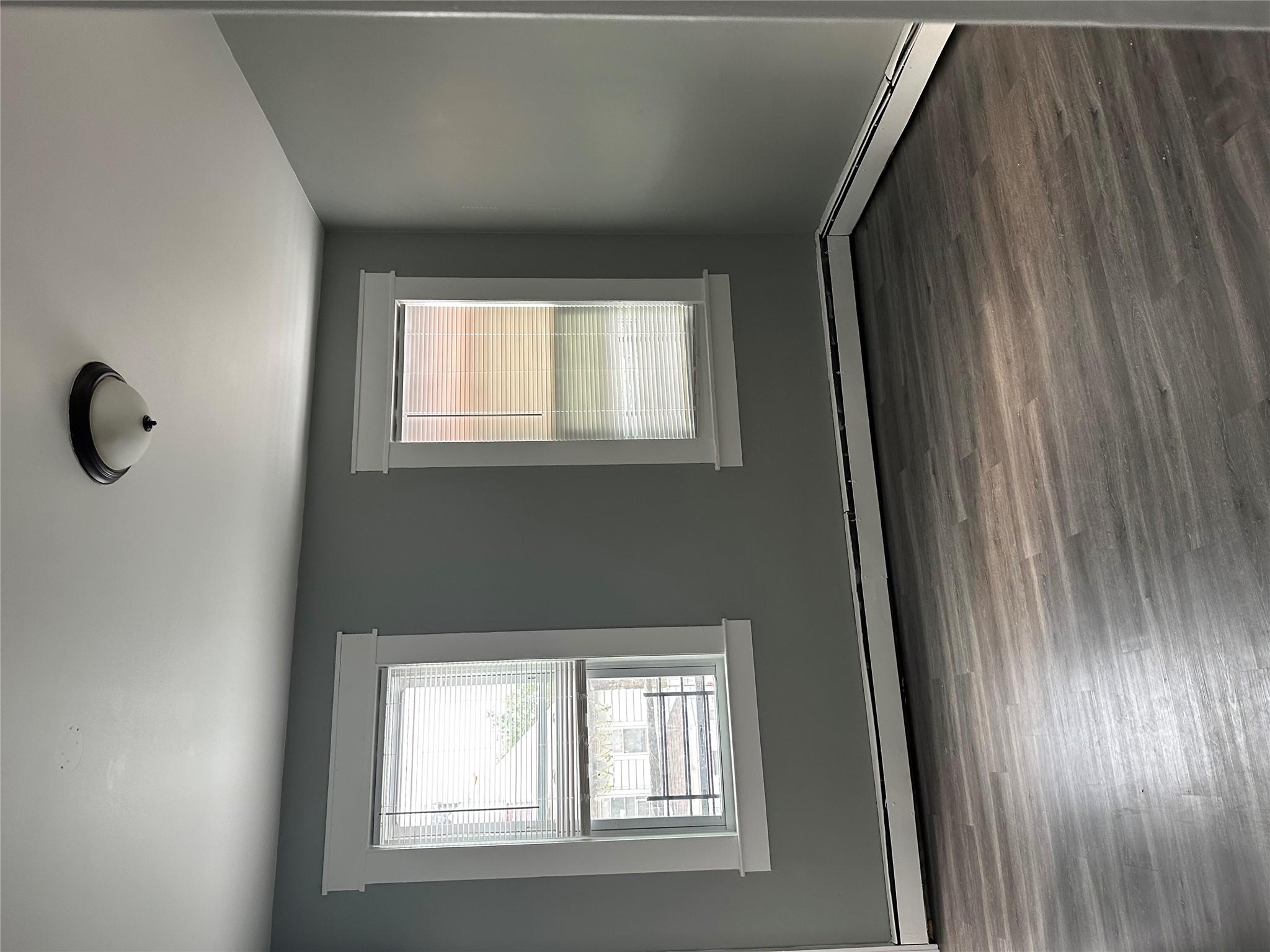 17 Chestnut Street Yonkers, NY 10701 - Photo 11 of 20 an empty room with wooden floor and windows