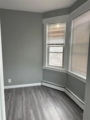 a view of wooden floor and brick walls
