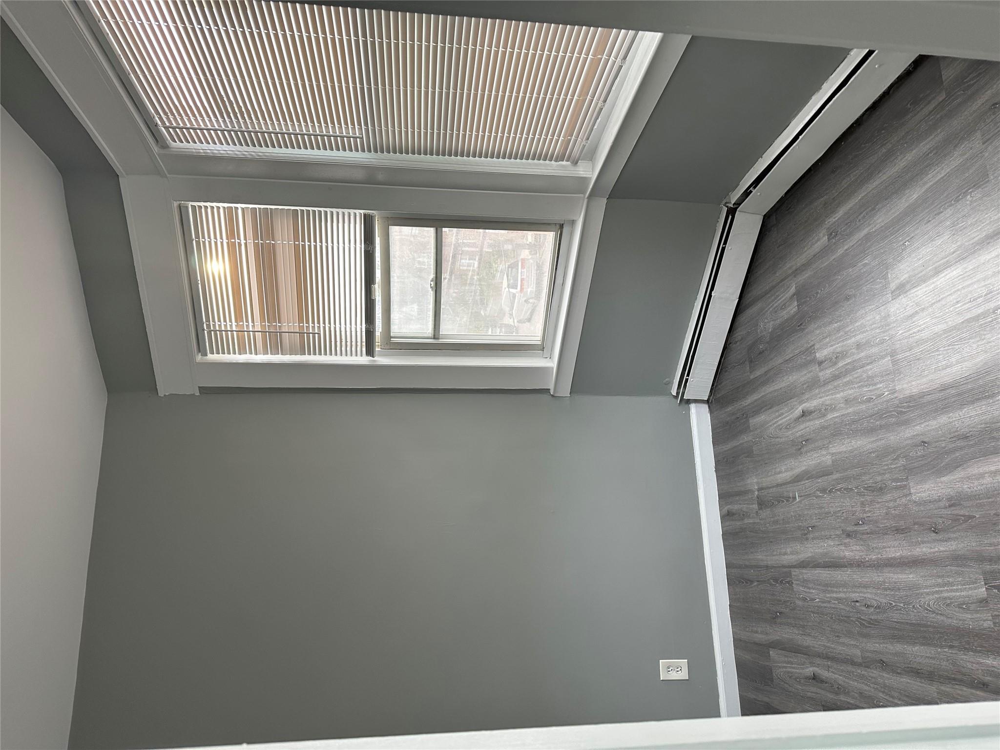 17 Chestnut Street Yonkers, NY 10701 - Photo 12 of 20 a view of an empty room with wooden floor and a window