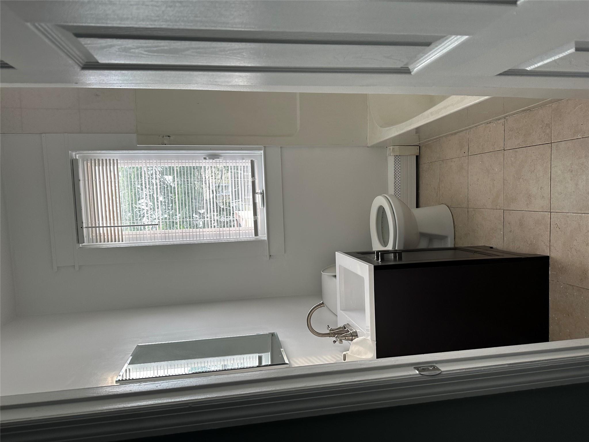 17 Chestnut Street Yonkers, NY 10701 - Photo 14 of 20 a bathroom with a toilet sink and mirror