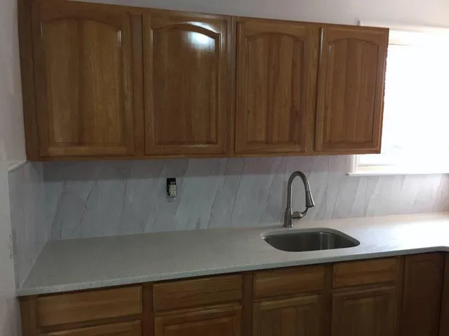 a kitchen with a sink cabinets and stainless steel appliances