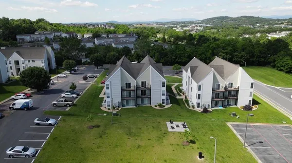 an aerial view of a house with swimming pool garden and mountain view in back