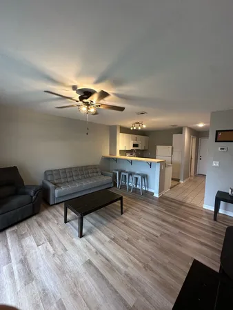 a living room with furniture a rug and a chandelier