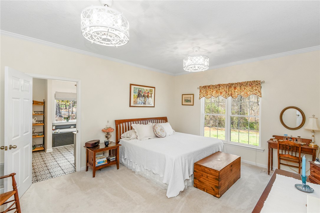 108 Pearman Drive Pendleton, SC 29670 - Photo 27 of 50 This cozy bedroom features a bright window and comfortable carpet flooring, offering a peaceful retreat.