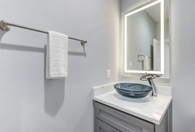 a bathroom with a sink and mirror